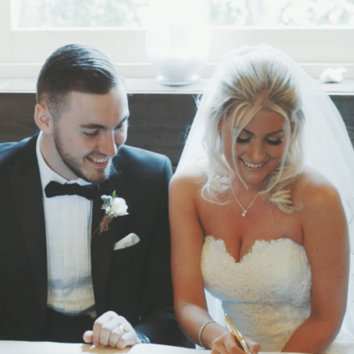 Bride and groom signing register