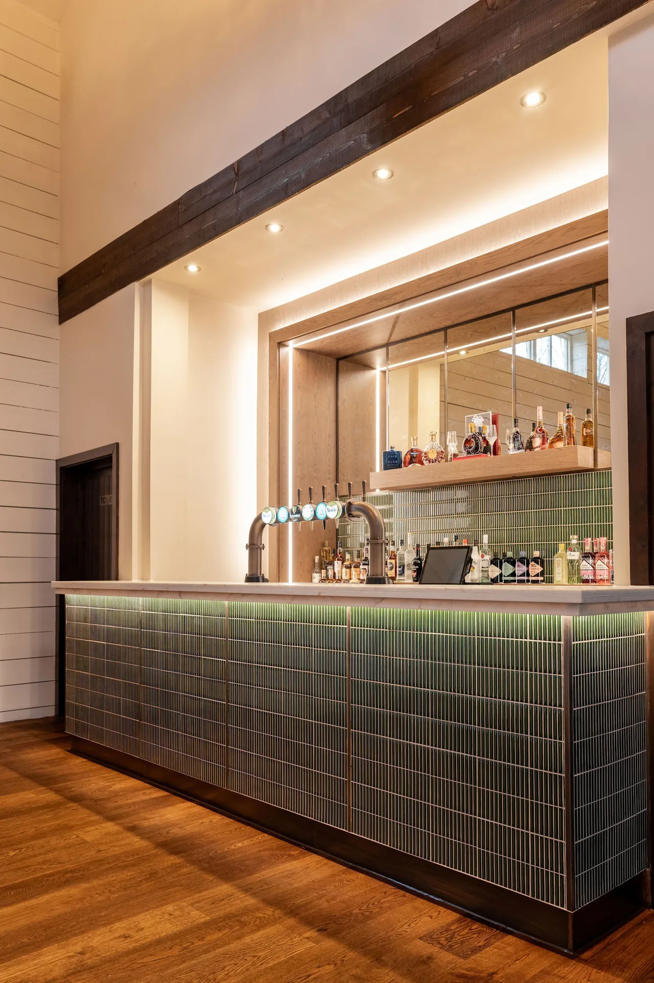 Brass beer taps at the tiled bar