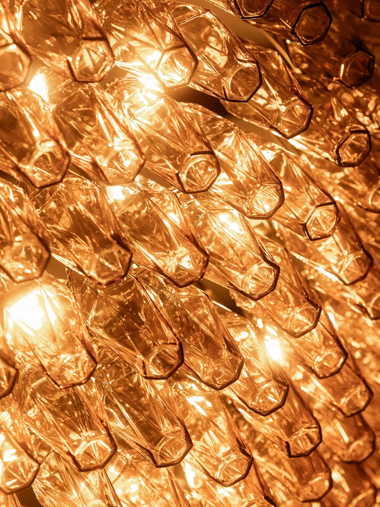 Close detail of the barn chandelier's amber glass rings