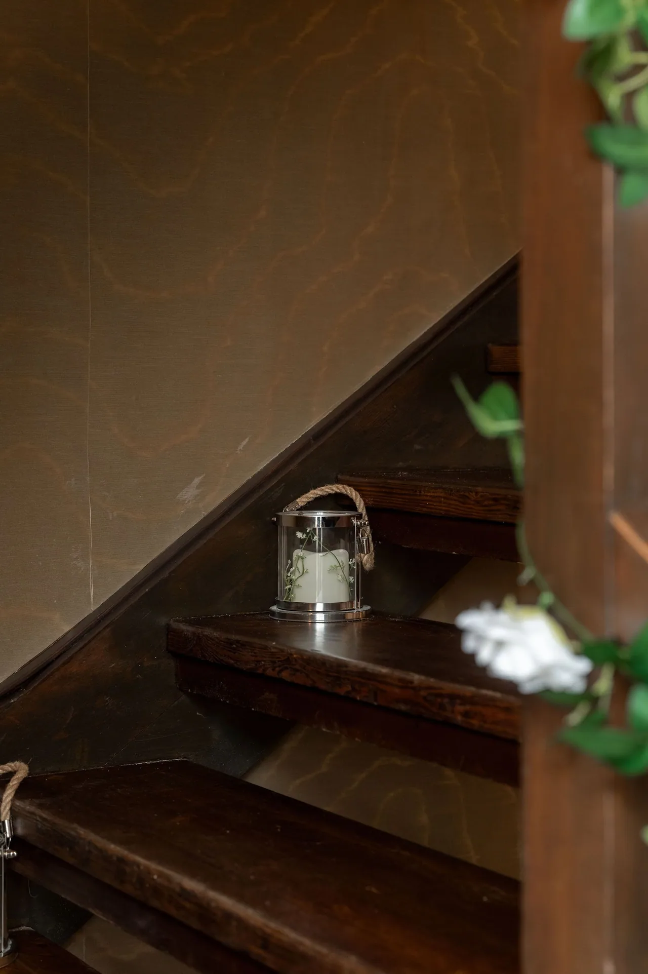 Small lantern resting on a dark timber beam